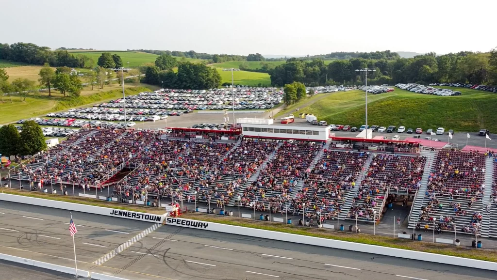 Aerial view of the packed Jennerstown Speedway grandstands and full parking lots on a race night