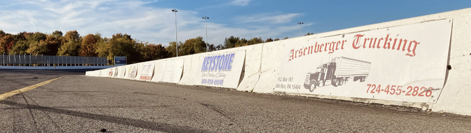 Sponsor signs painted the length of the pit lane retaining wall