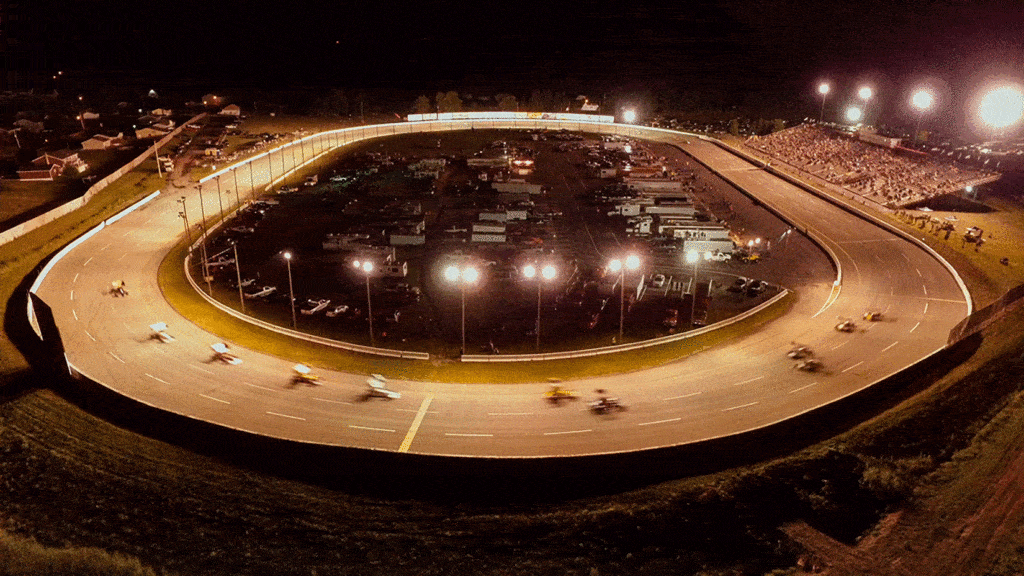 Aerial view of the lit speedway at night
