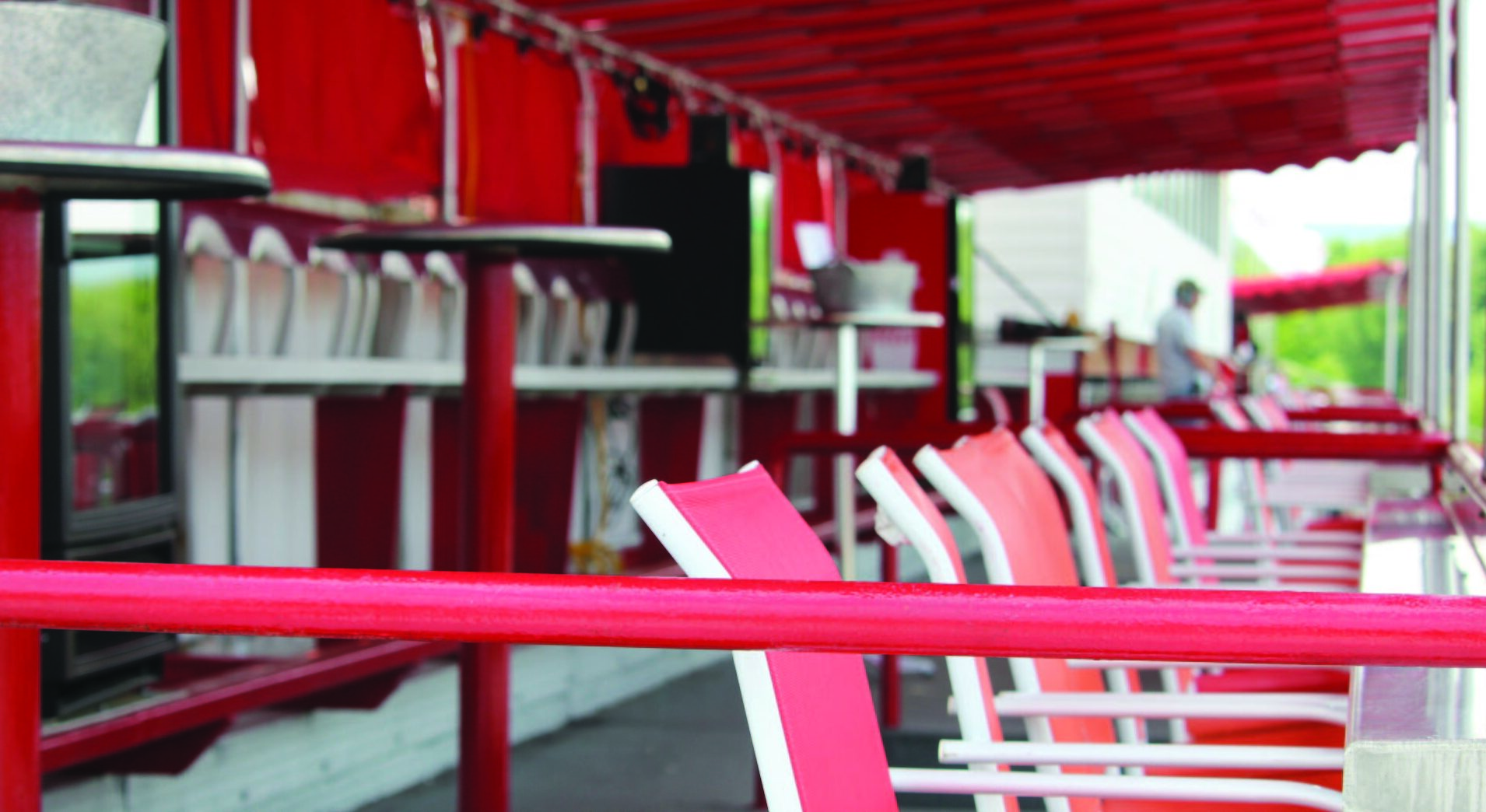 Rows of red and white seats under the grandstand canopy